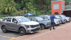 A man walks past vehicle imported into Kingstown on Thursday, May 8, 2025.